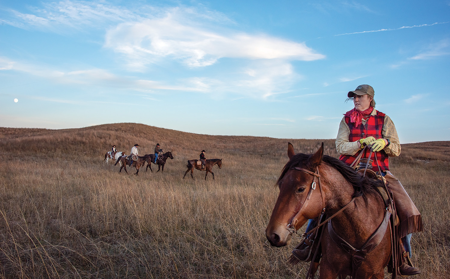 Sarah Sortum and her family ride horseback in the evening on the Switzer Ranch in Loup County.